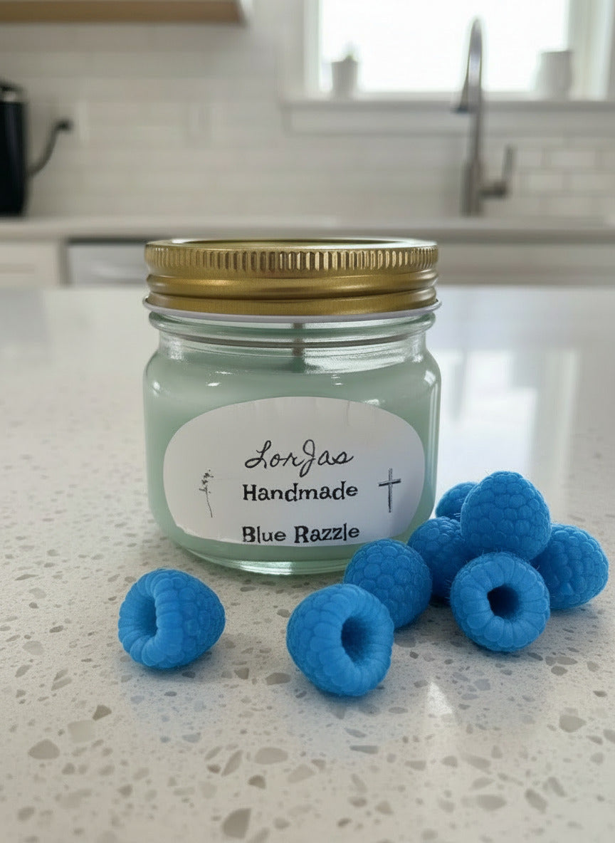 LorJas Handmade 'Blue Razzle' scented organic soy candle on marble counter beside fresh blue raspberries with kitchen in background