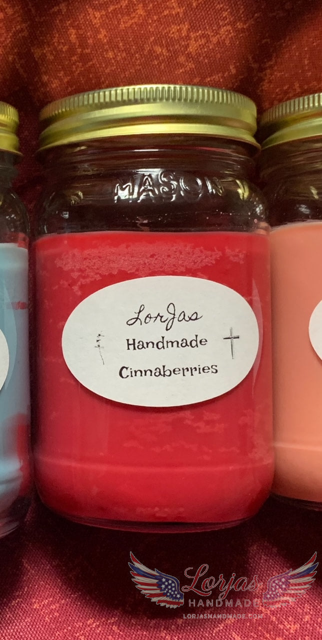 16 ounce mason with a gold watertight lid labeled 'LorJas Handmade Cinnaberries' on a red fabric background