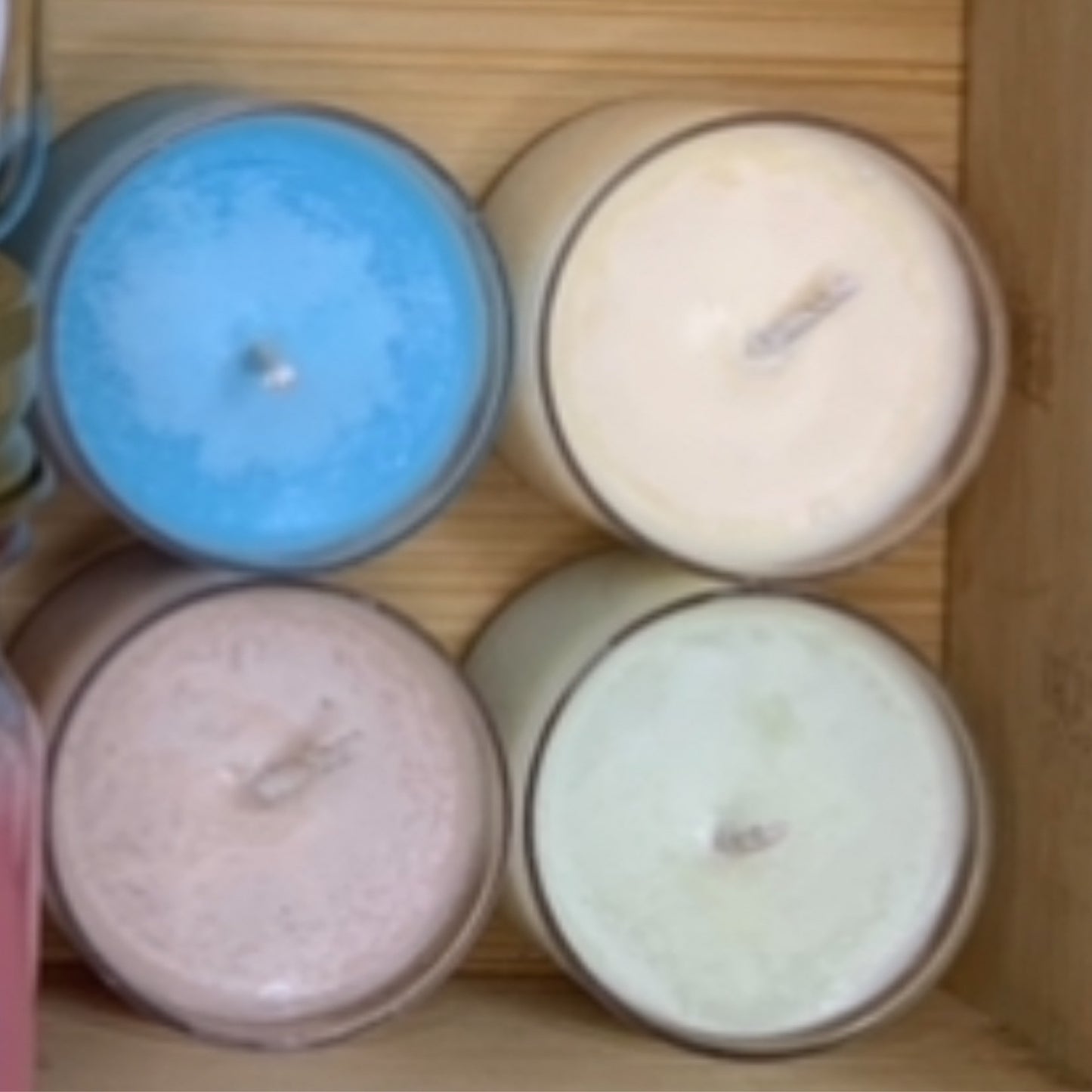 Five LorJas Handmade organic soy tealights in various colors and scents arranged on a wooden surface.