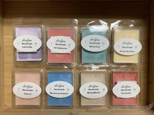Sample set of LorJas Handmade organic soy scented wax melts in labeled packaging in wooden display box.