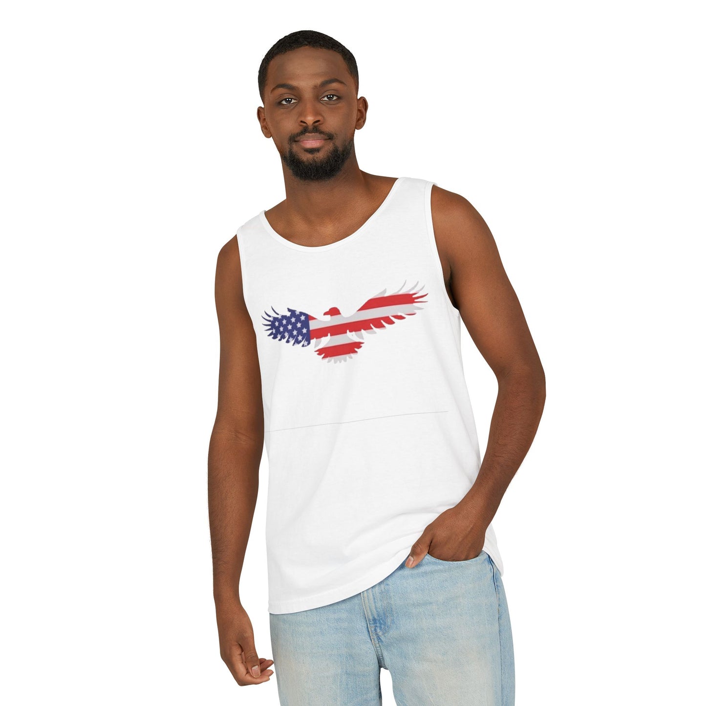 A man wearing a white sleeveless tank top with a distressed American flag eagle graphic on the chest, paired with light blue jeans, against a plain white background.