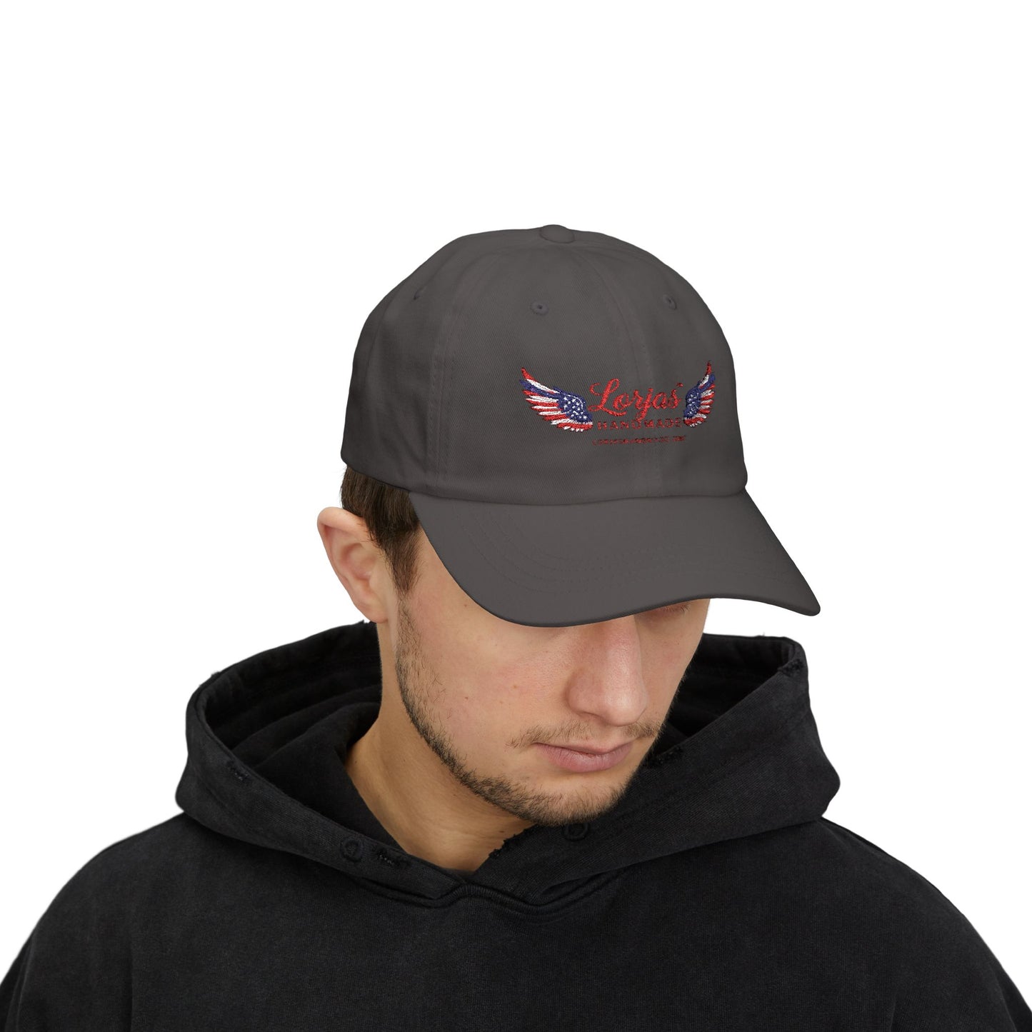 Man wearing a dark gray cap with a LorJas Handmade branded logo on a white background