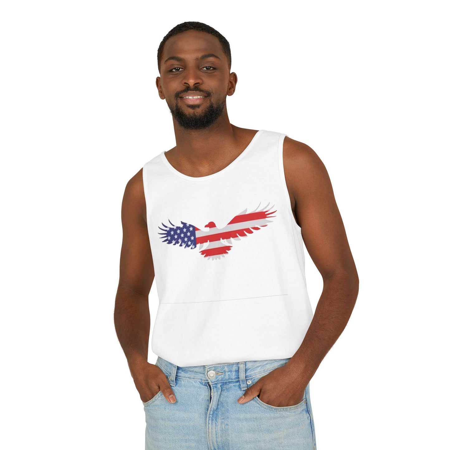 A man wearing a white sleeveless tank top with a red, white, and blue eagle graphic printed on the chest, paired with light blue jeans, against a plain white background.