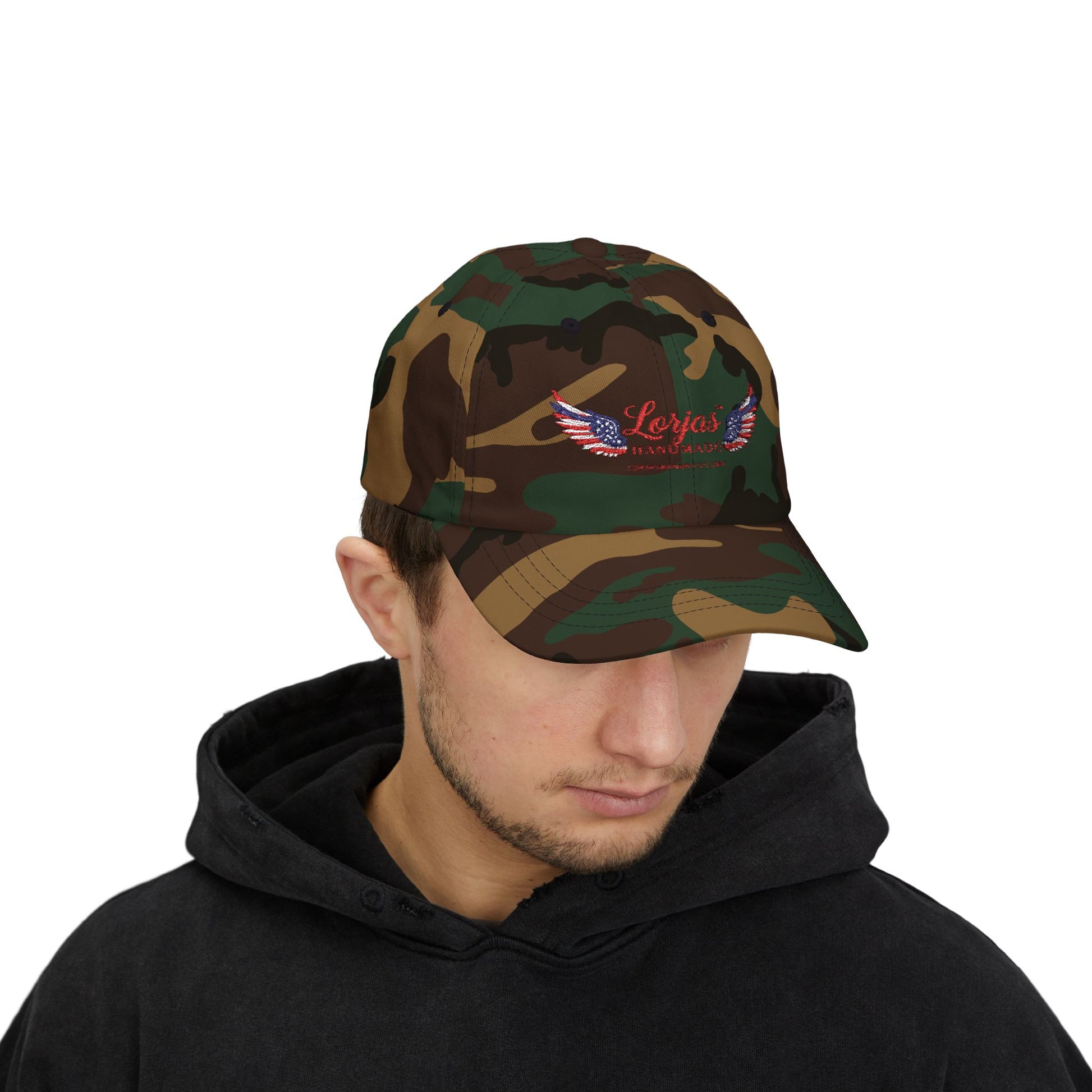 Person wearing a camouflage cap with LorJas Handmade brandind on a white background