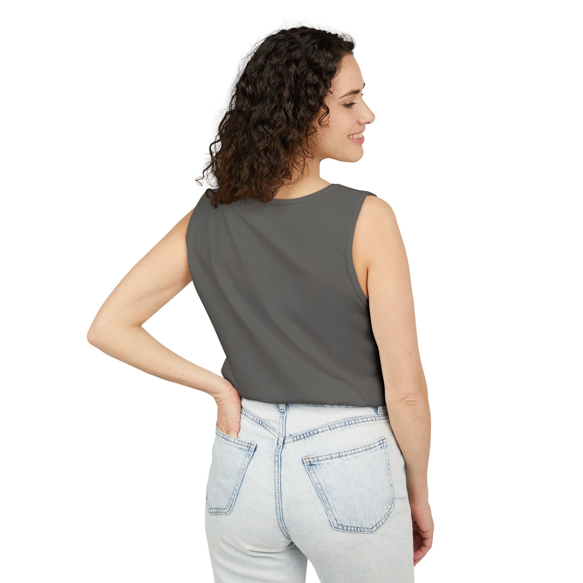 Woman wearing a gray sleeveless top and light blue jeans on a white background