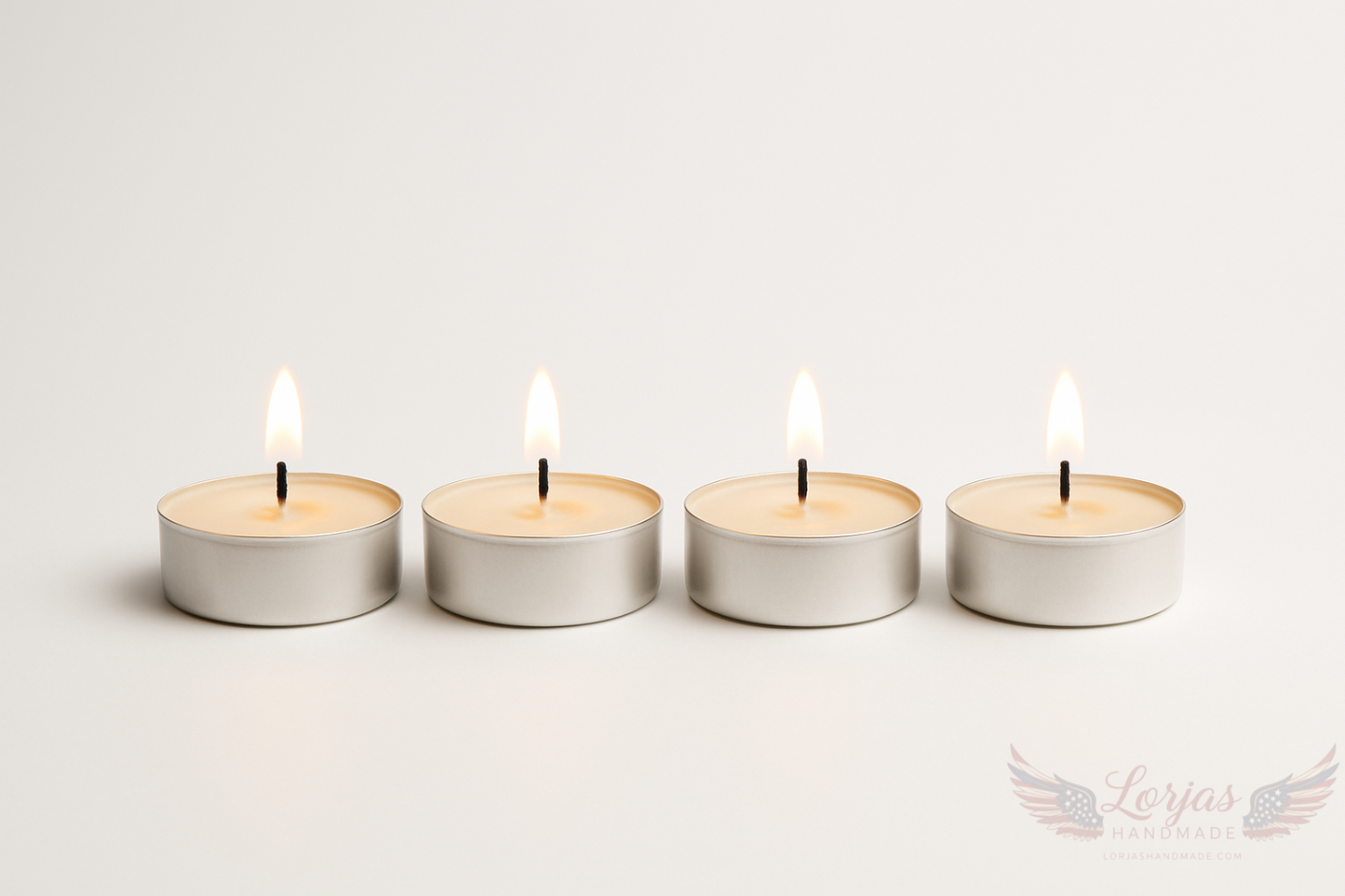 4 lit light beige tea lights in a row with a white background