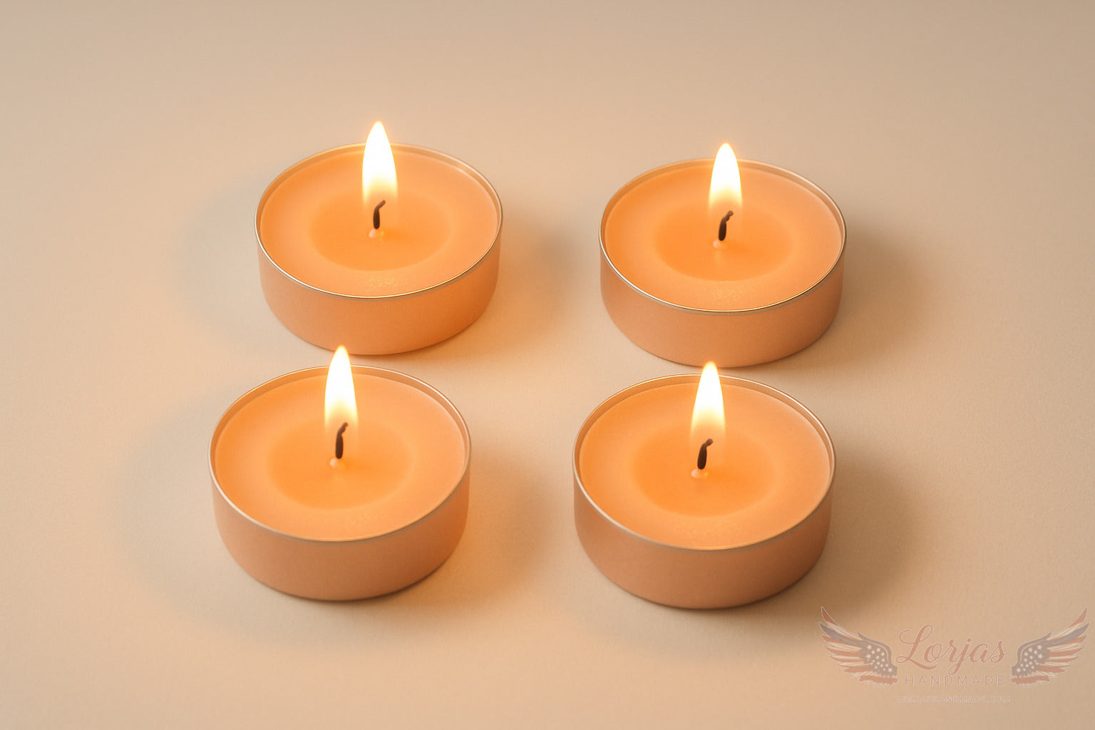 Four lit peach tealight candles on a beige background with LorJas Handmade logo in corner