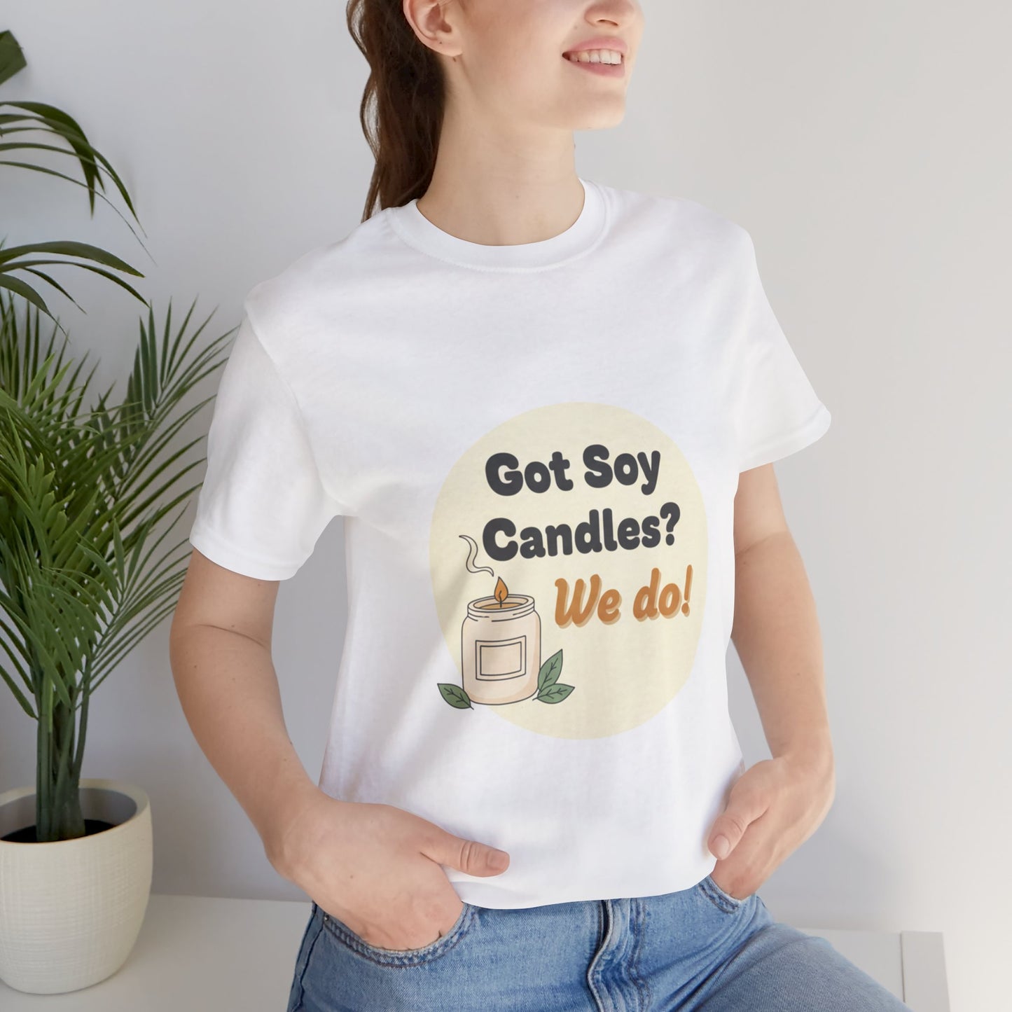 Female model wearing a white t-shirt with 'Got Soy Candles? We do!' graphic design.