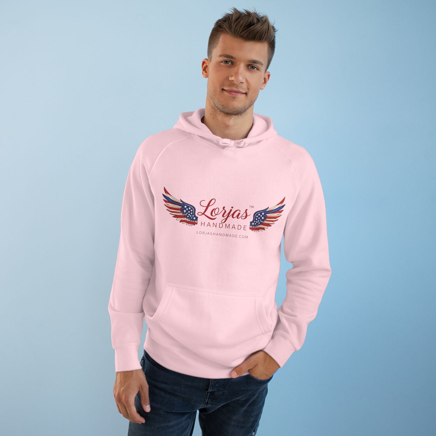 Man wearing a pink hoodie with 'Lorjas Handmade' logo on a light blue background