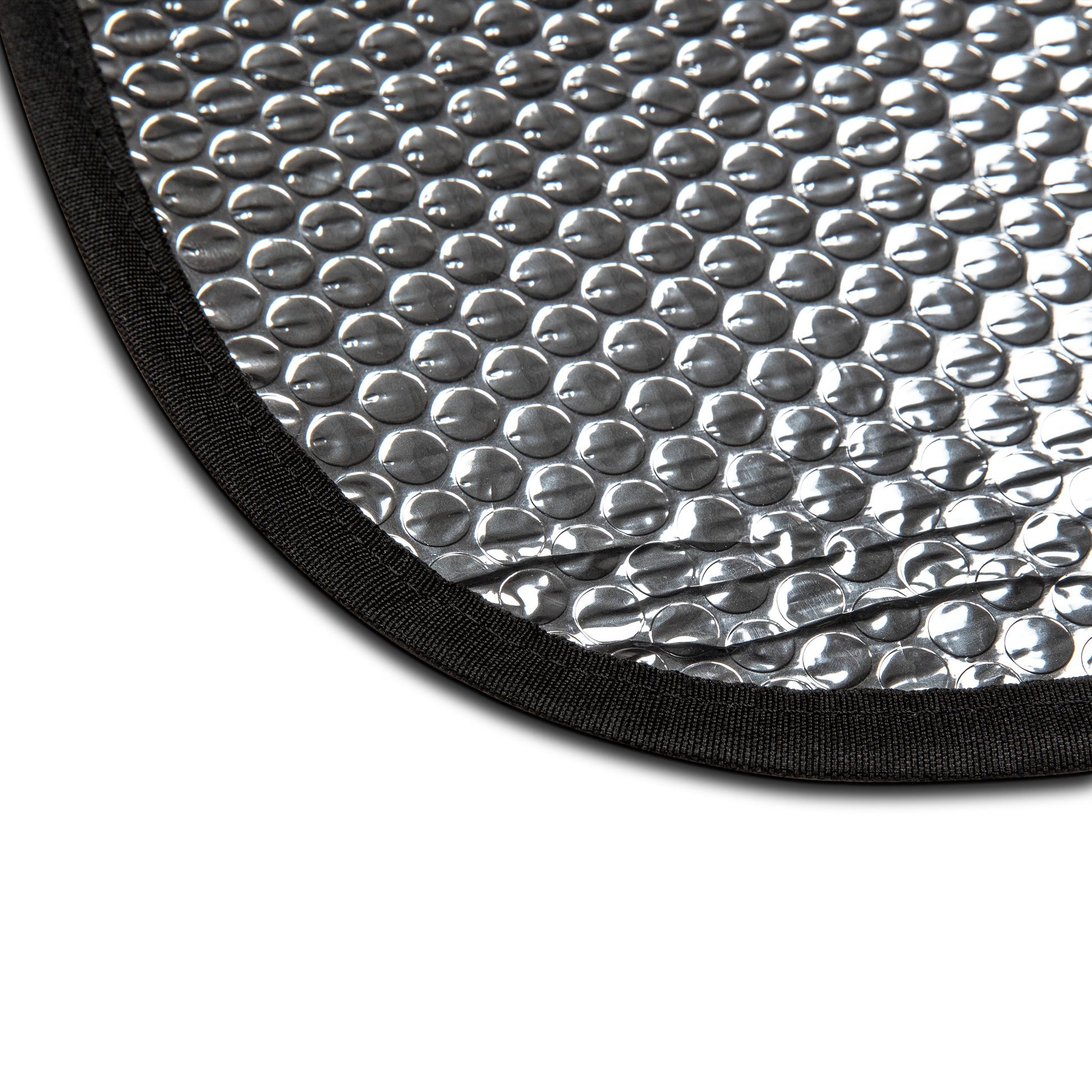 Close-up of a textured silver mat with black border on a white background