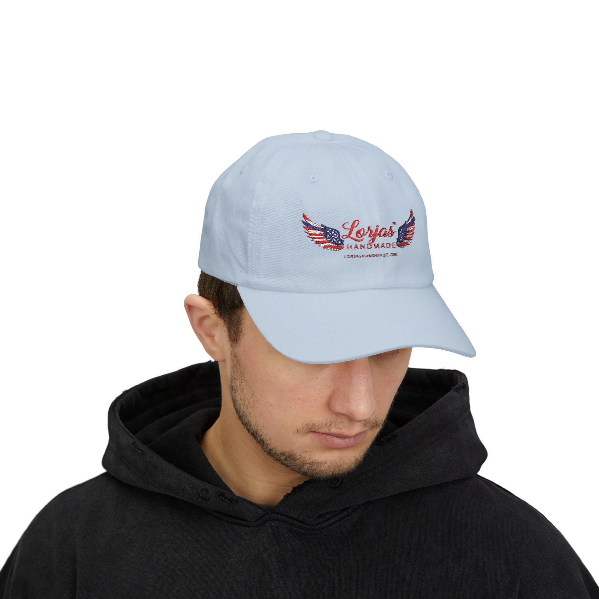 Light blue cap with LorJas Handmade branding worn by a person on a white background