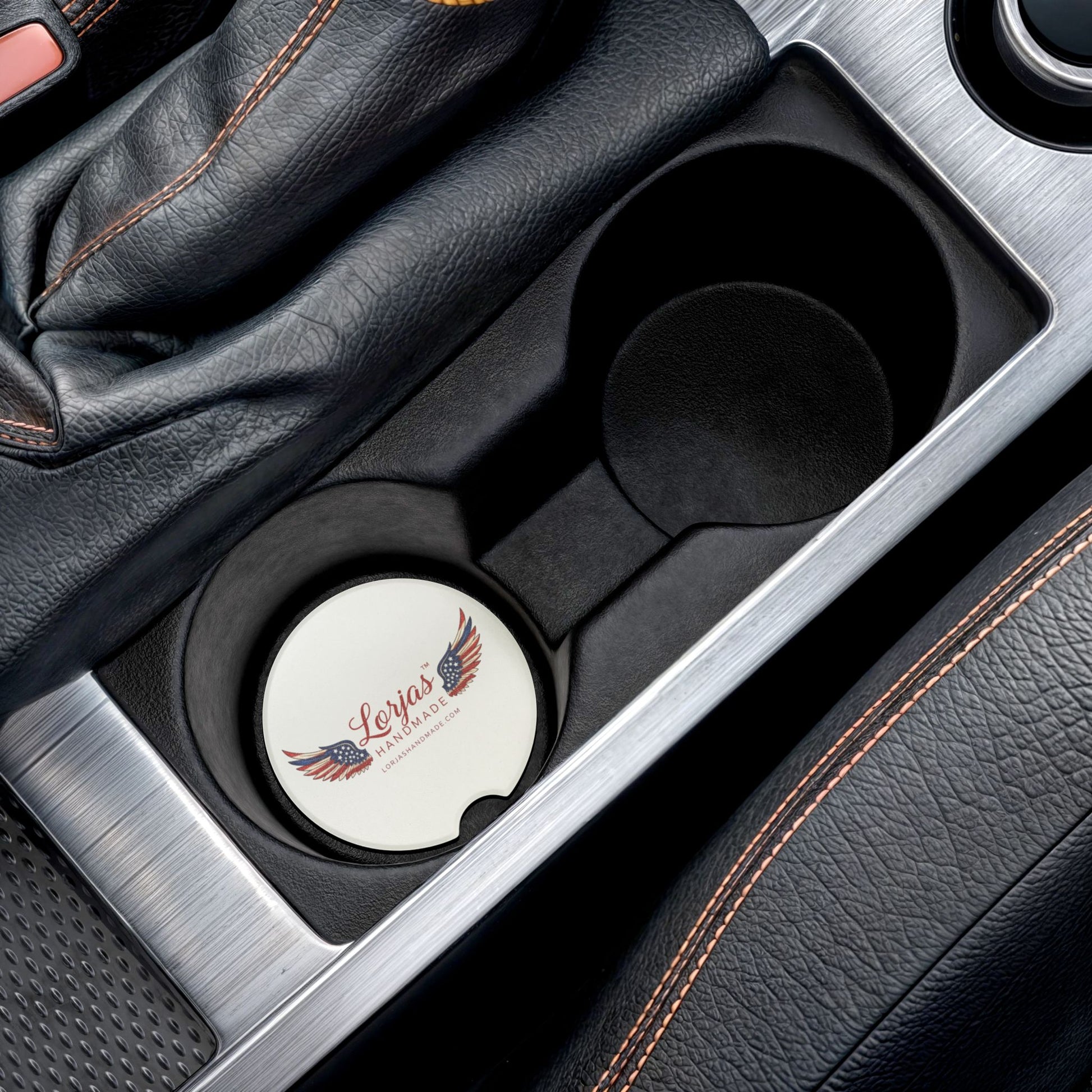 Car cup holder with a 'Lorjas Handmade' branded coaster inside