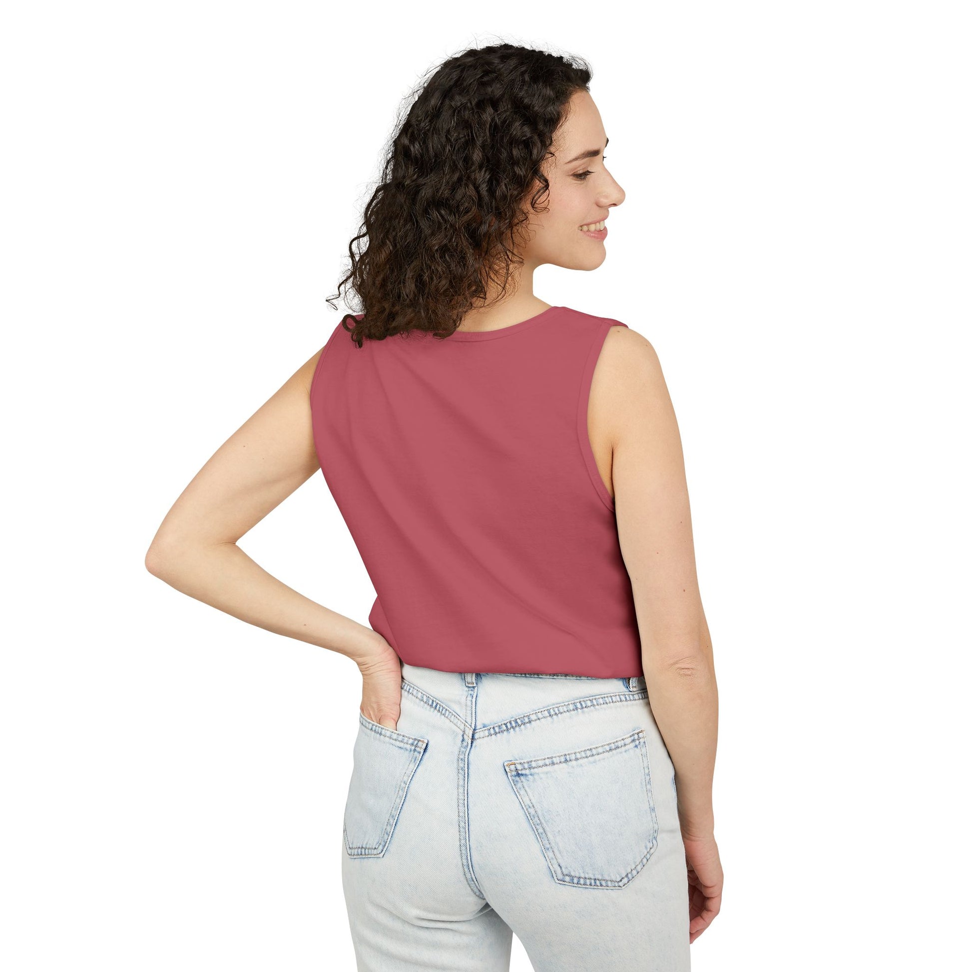 Woman wearing a sleeveless top and jeans on a white background