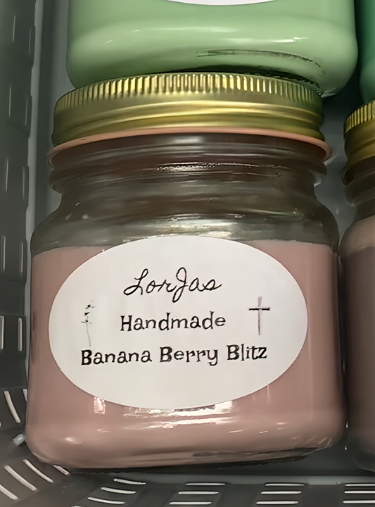 Jar of 'Handmade Banana Berry Blitz' scented organic soy candle with a label laying in a basket