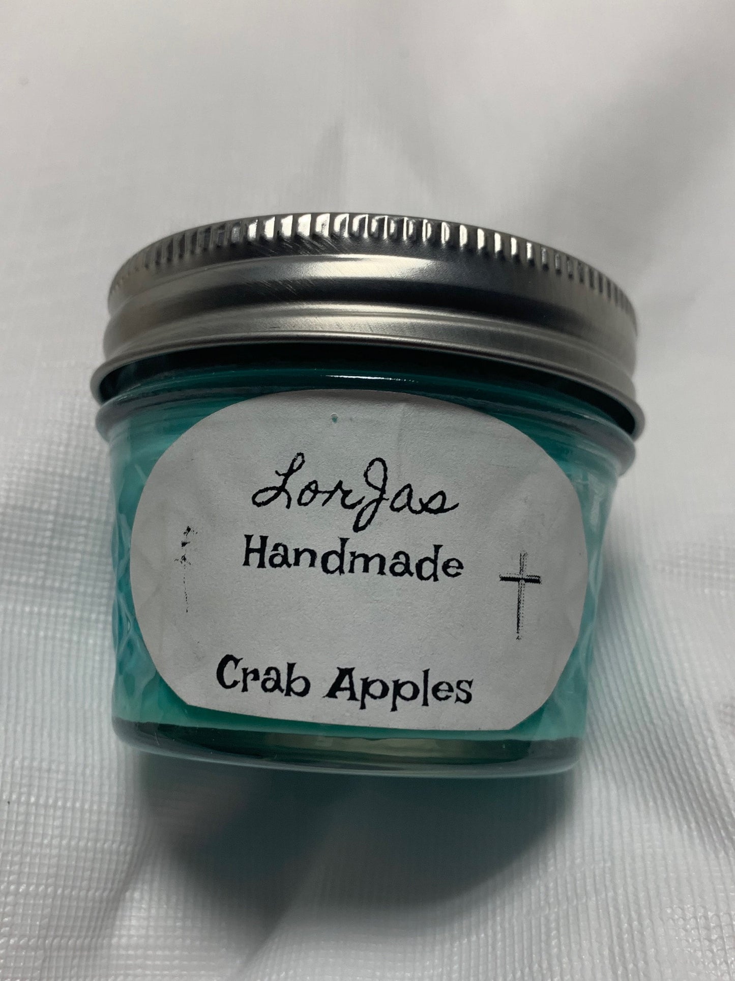 Jar of LorJas Handmade 'Crab Apples' scented organic soy candle with a label on a white background