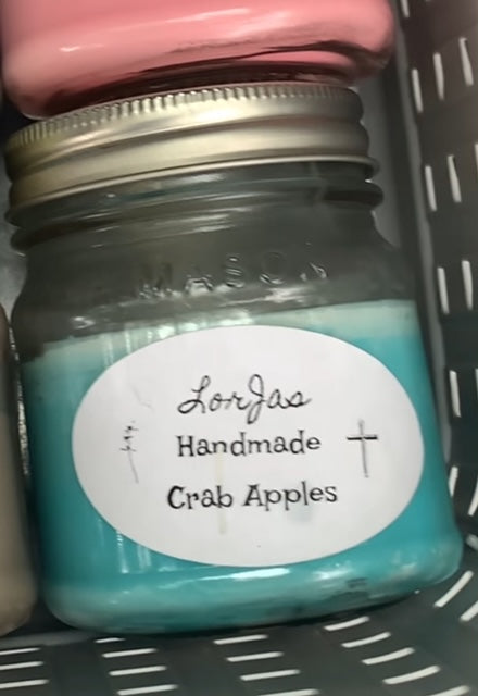 Jar of LorJas Handmade 'Crab Apples' scented organic soy candle with a label on a gray surface