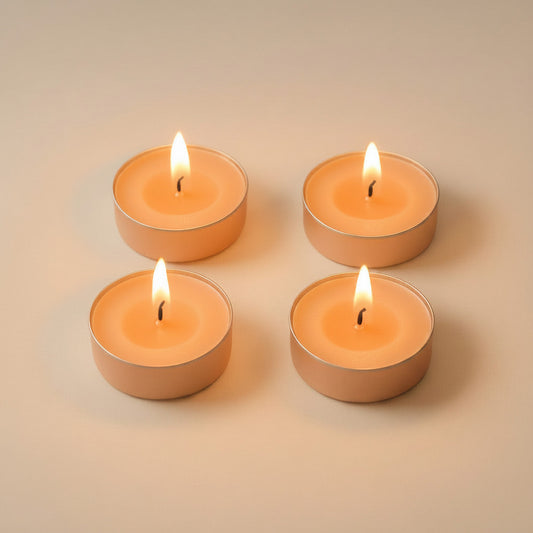 Four lit peach LorJas Handmade lightly scented soy tealights on a beige background featuring brand logo.