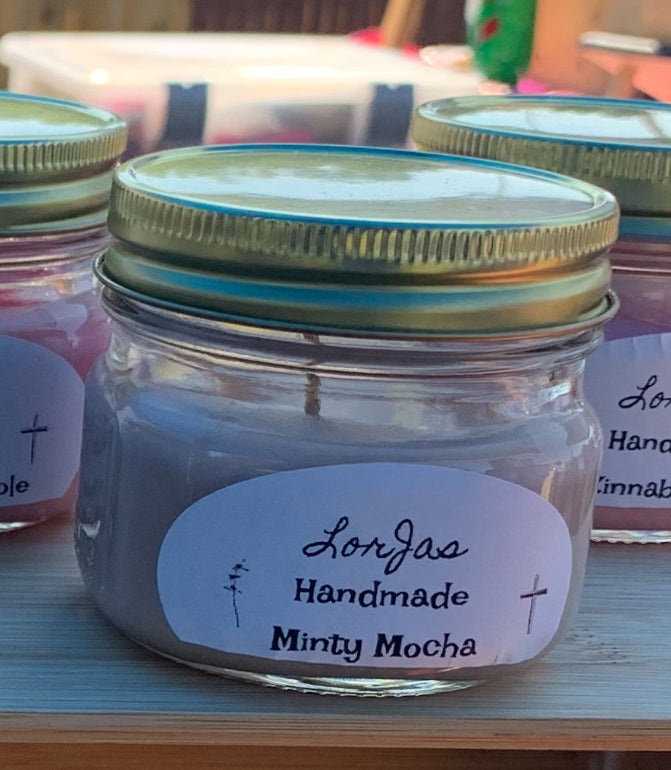 Jar of 'Lorjas Handmade Minty Mocha' with a label on a wooden surface.