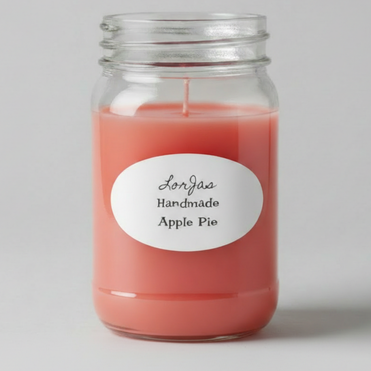 Lorjas Handmade 'Apple Pie' lightly scented soy candle with gray studio backdrop.