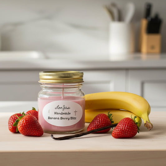LorJas Handmade Banana Berry Blitz lightly scented soy candle beside fresh strawberries, ripe bananas, and a vanilla bean on a wooden countertop with a blurred kitchen backdrop.