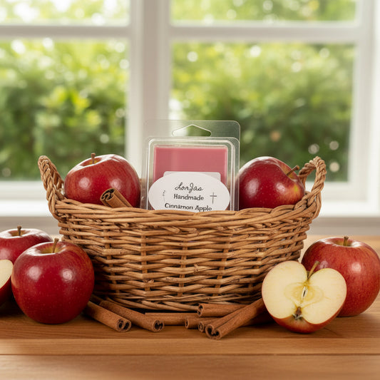 LorJas Handmade Cinnamon Apple lightly scented organic soy melts in a wicker basket with fresh apples and cinnamon sticks on wooden surface with window in background.