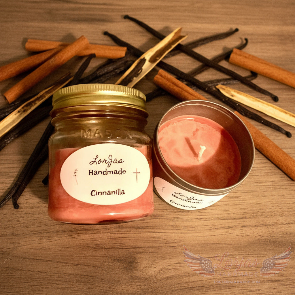 Handmade candle in a mason jar with a matching tin, labeled 'LorJas Handmade Cinnanilla' with fresh cinnamon sticks and vanilla beans on wooden surface.