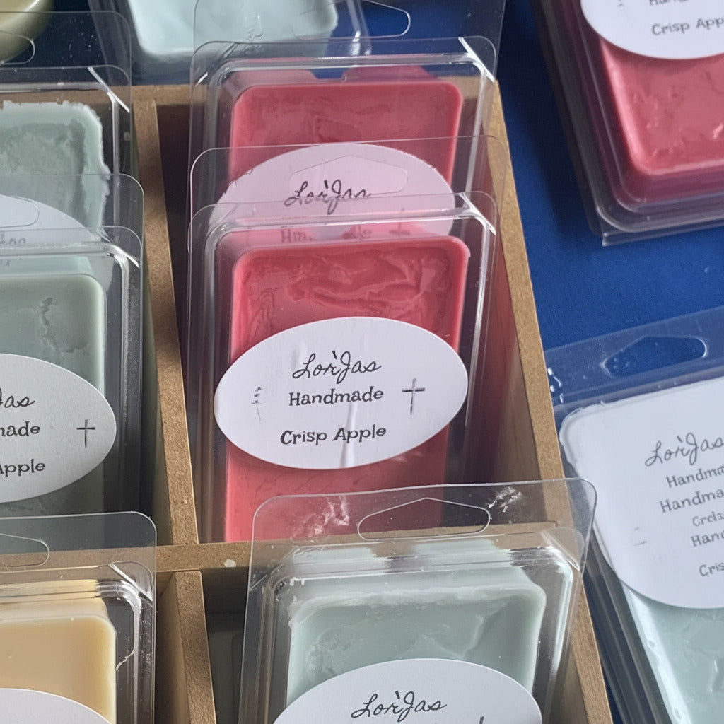 OLorJas Handmade Red Crisp Apple lightly scented soy melt in brand package on table at market in wood display box.