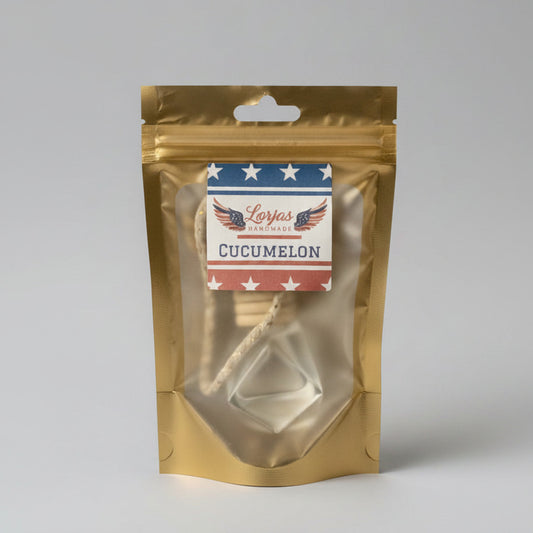 LorJas Handmade Cucumelon lightly scented car diffuser in gold branded packaging in a studio setting.