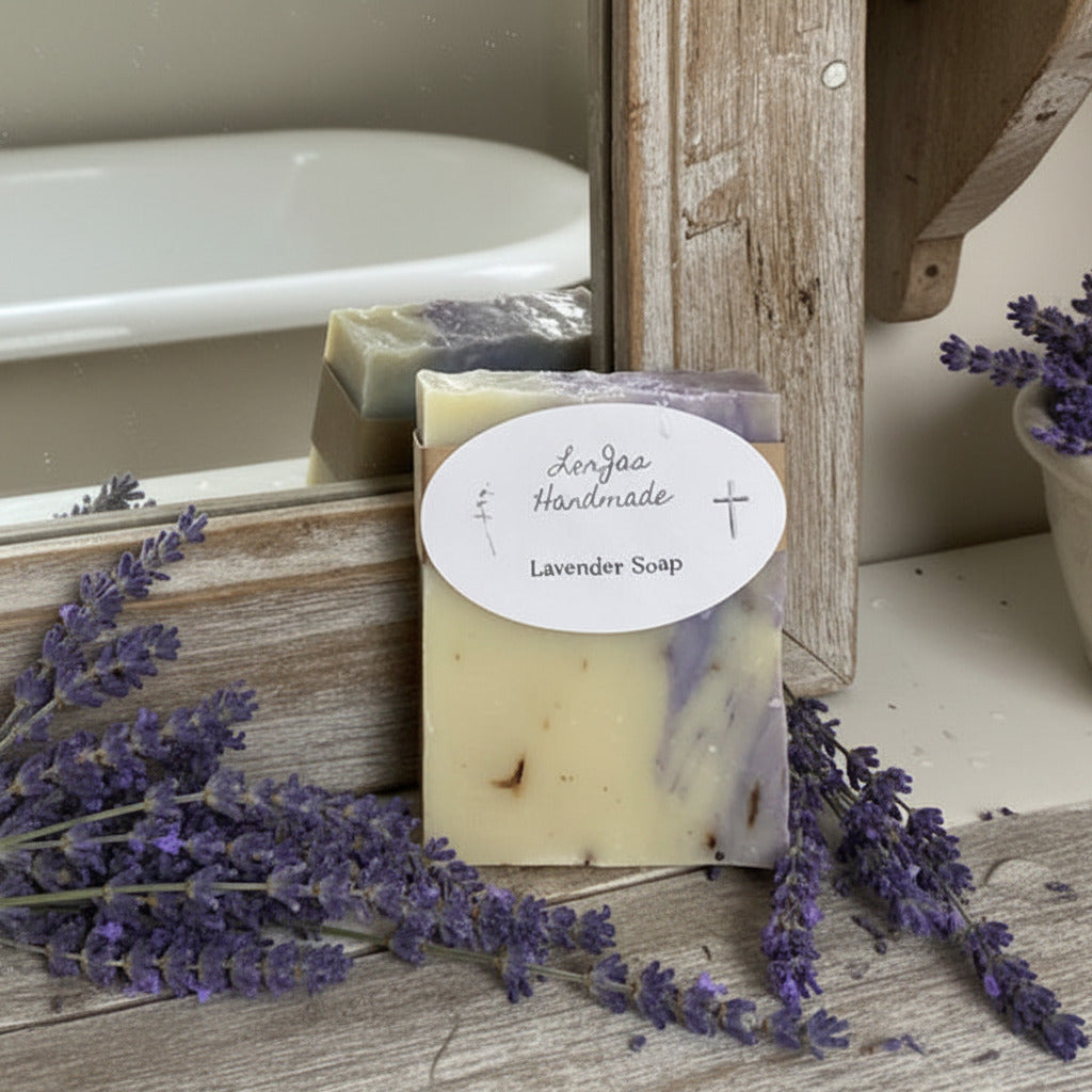 LorJas Handmade Lavender lightly scented Castile soap beside fresh lavender leaning on mirror with reflection of antique standing tub