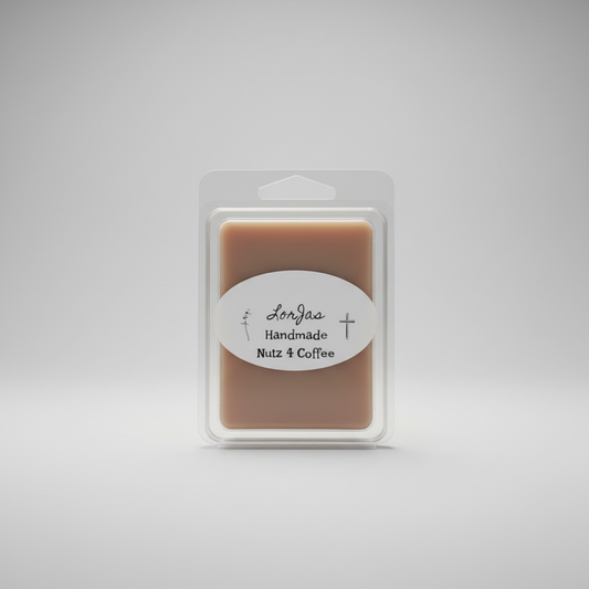 A packaged wax melt in a clear plastic clamshell package on a light gray studio background. The product inside is a warm tan-brown rectangular bar with a white oval label reading LorJas Handmade 'Nutz 4 Coffee'.