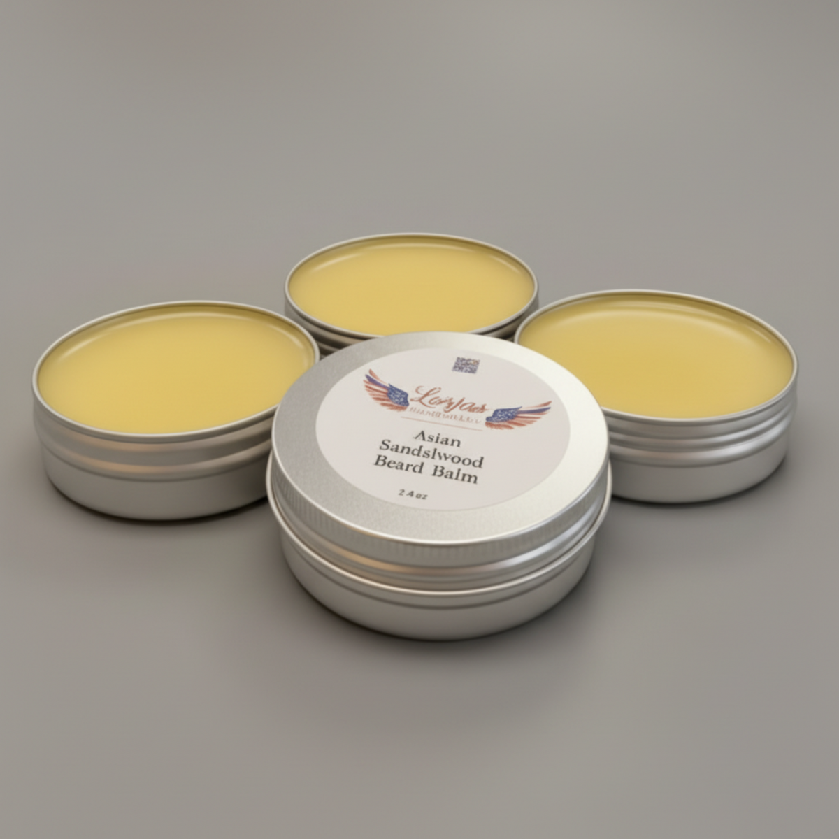 Four tins of Lor’Jas Handmade lightly scented Asian Sandalwood beard balm with studio background.