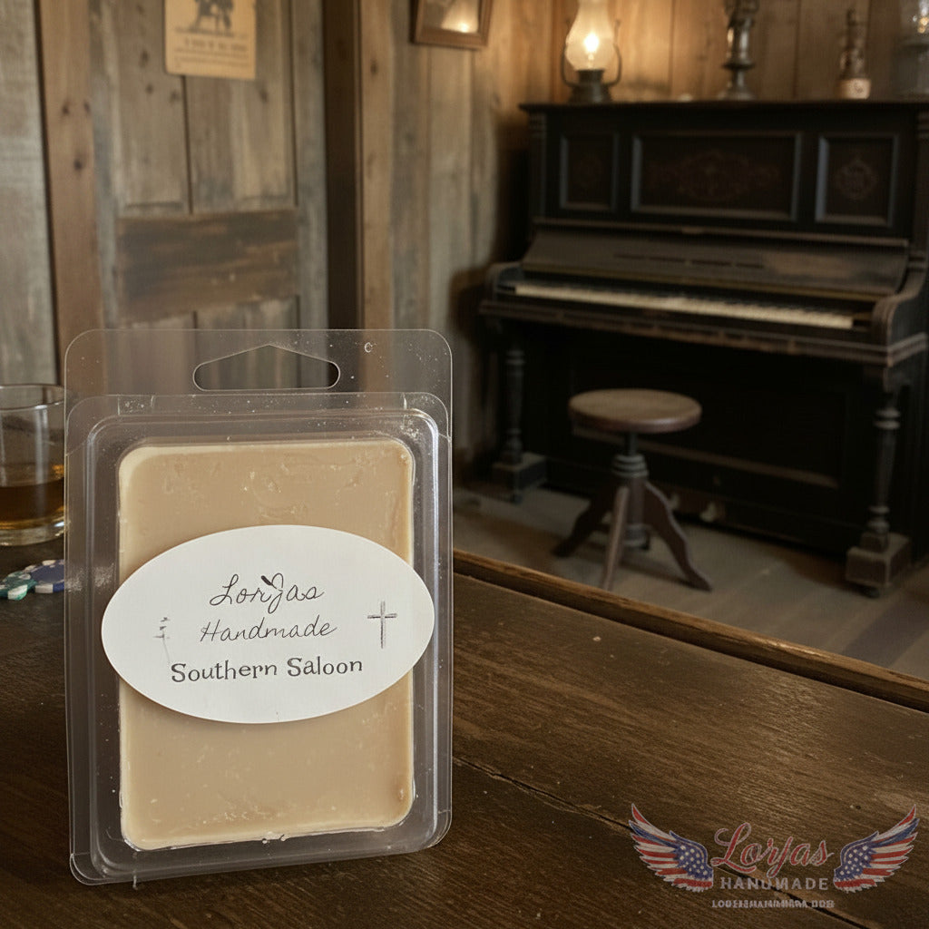 LorJas Handmade Southern Saloon lightly scented soy wax melt on a rustic wooden bar in an old saloon setting with a piano and stool in the background.