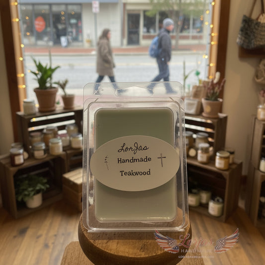 LorJas Handmade Teakwood lightly scented melt on a wooden surface with a mercantile window background.