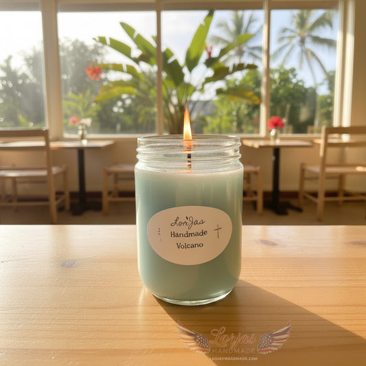 LorJas Handmade Volcano lightly scented soy candle on a wooden table in a restaurant with a scenic tropical window view in natural light.