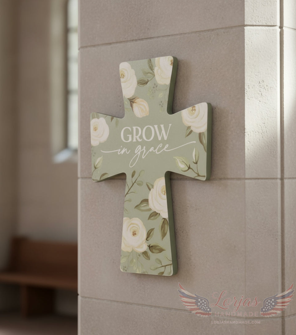 Decorative cross wall hanging with floral design and 'Grow in grace' text on a tiled wall.