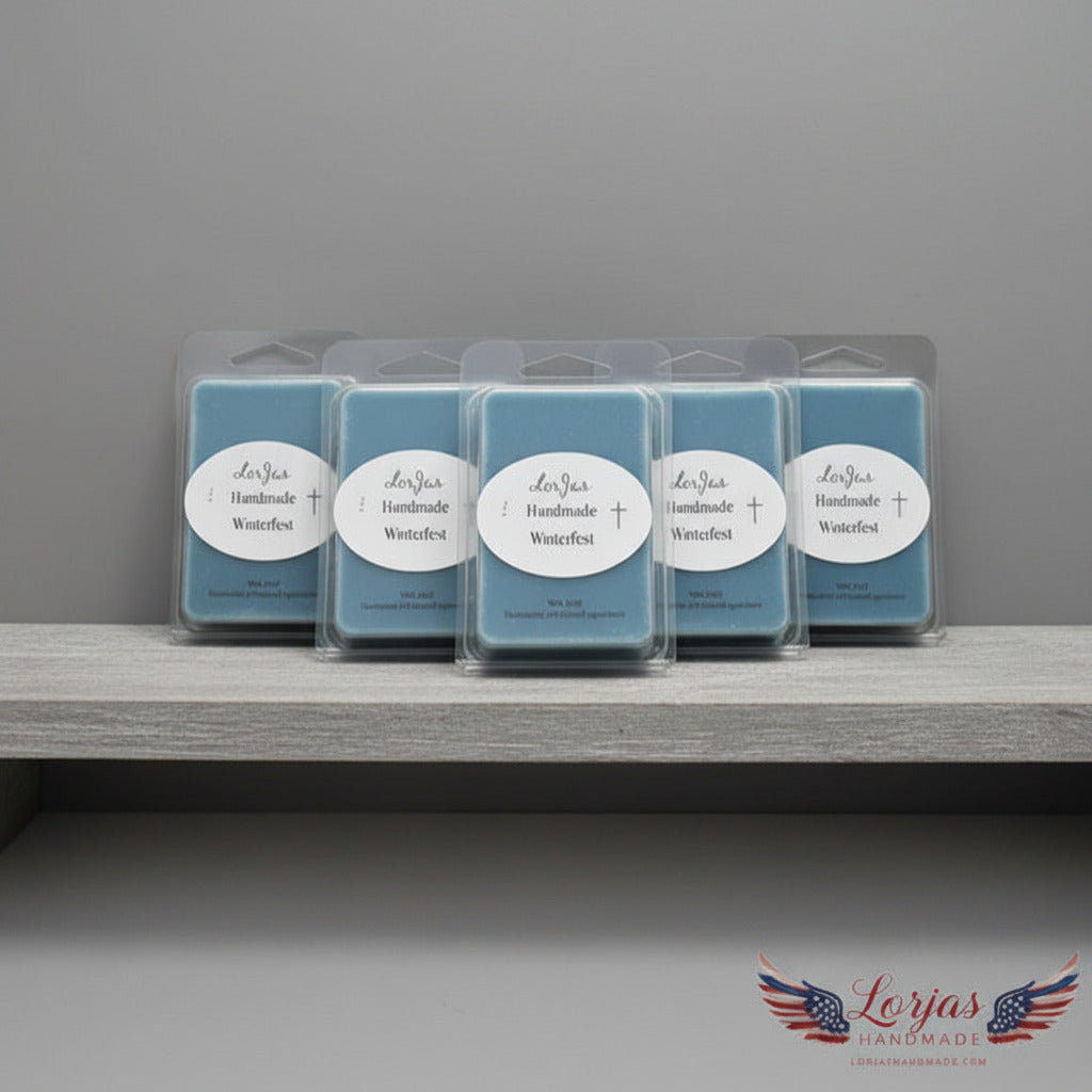 Five blue LorJas Handmade Winterfest lightly scented soy wax melts on a wooden shelf with a gray backdrop featuring LorJas Handmade brand logo.