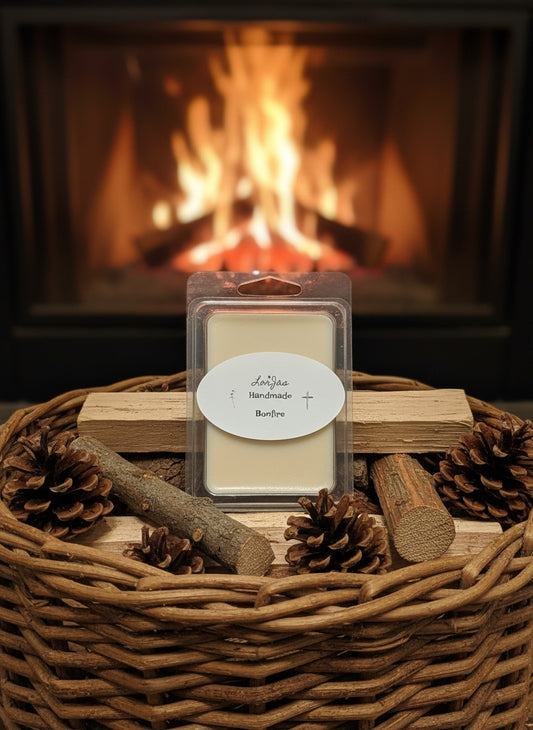 LorJas Handmade 'Bonfire' scented soy wax melt in basket with fire starter wood and pine cones in front of nice, warming fireplace