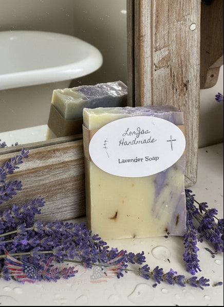LorJas Handmade 'Lavender' scented organic Castile soap beside fresh lavender leaning on mirror with reflection of antique standing tub