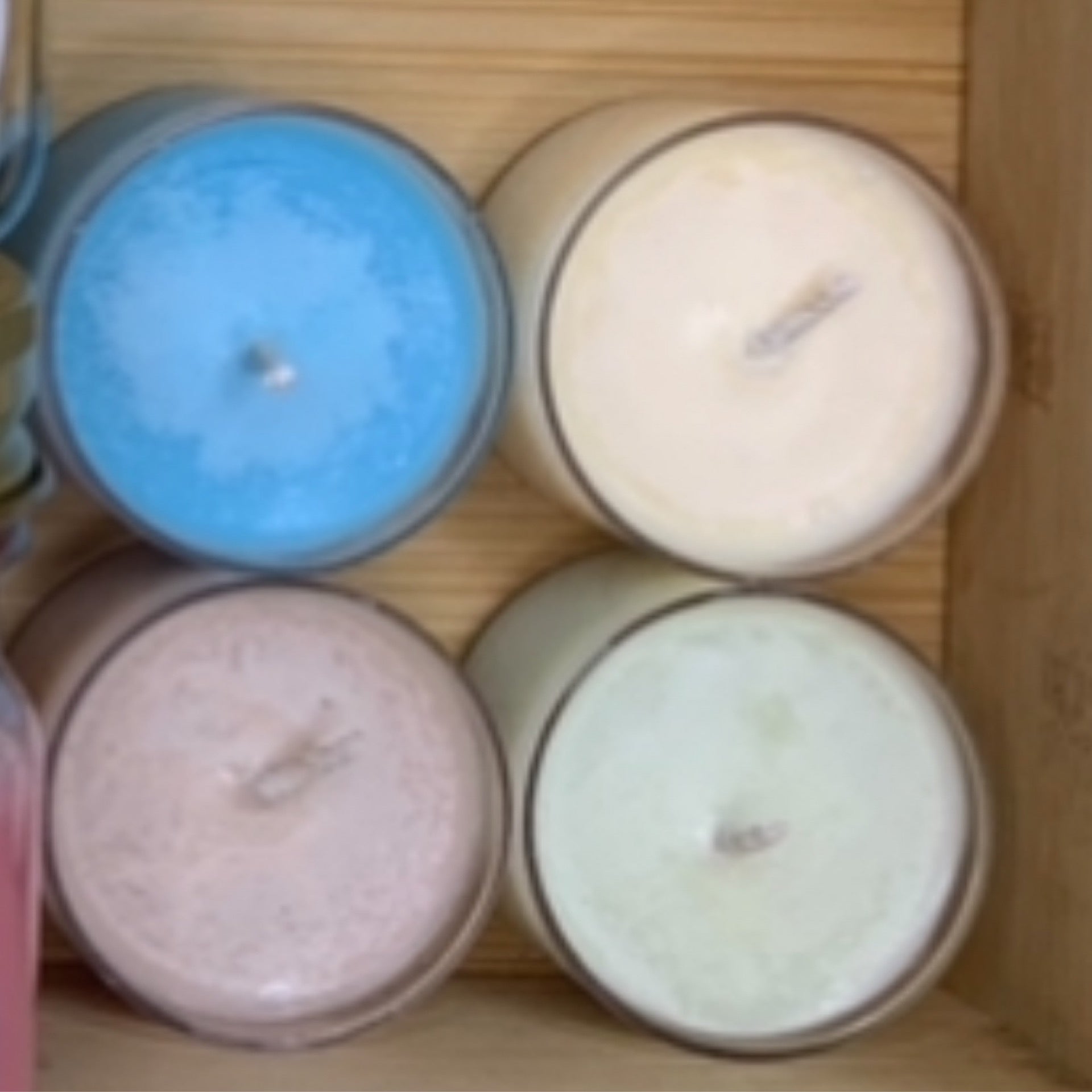 Five LorJas Handmade organic soy tealights in various colors and scents arranged on a wooden surface.